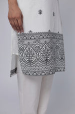 Close-up of the intricate black and white geometric detailing on the hem of the off-white cotton jacquard kurta and top of the matching pants.
