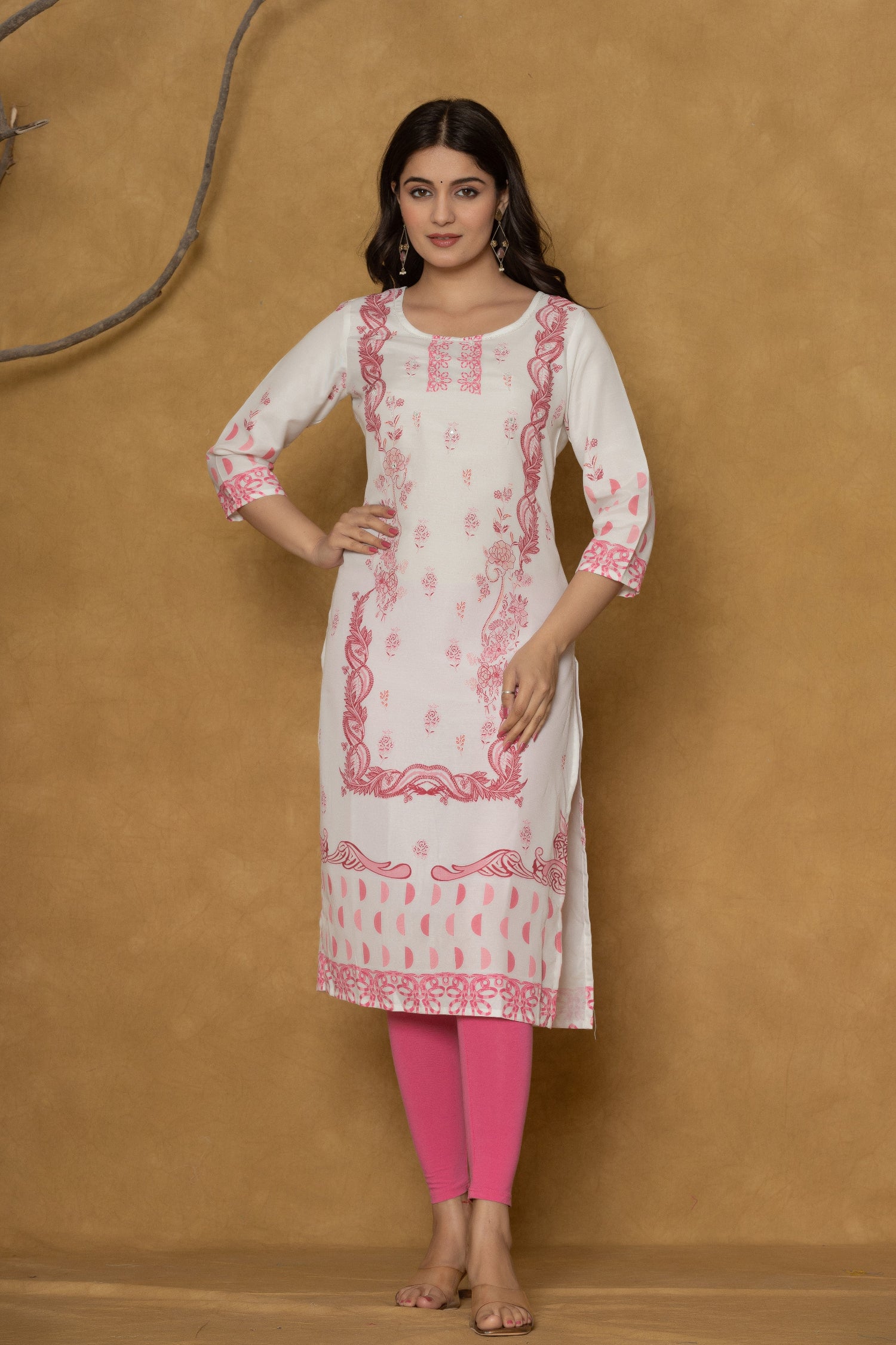 Model in a different pose wearing the white pannel kurta, highlighting the full length and the subtle pink floral patterns at the bottom.