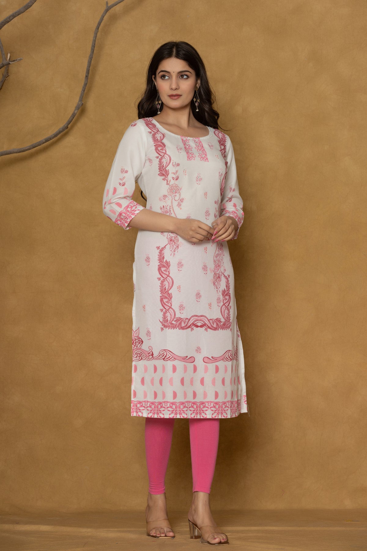 Close-up of the delicate pink floral and geometric pattern along the hemline of the white pannel kurta, showcasing the fabric and design detail.
