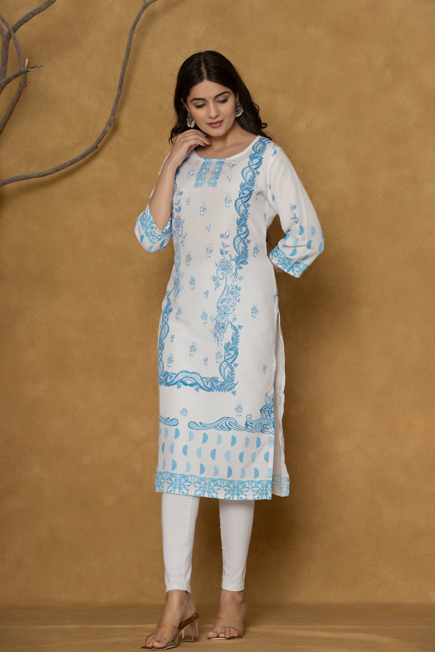 Side profile of model showcasing the comfortable fit and elegant blue handwork details of the white kurta.
