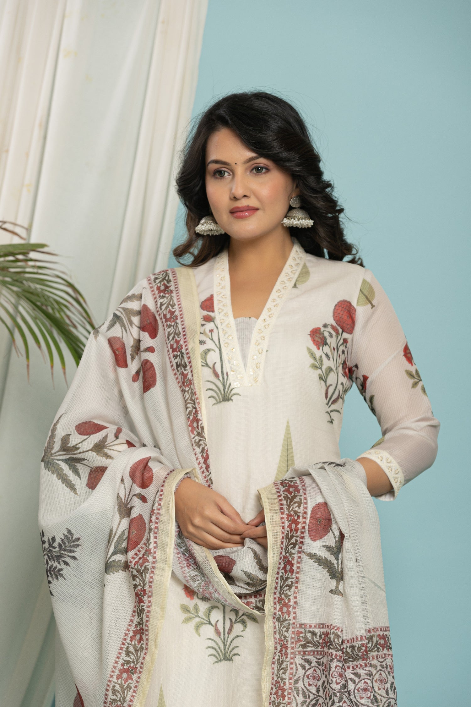 Close-up of the red and green floral block print design on the white kurti of the Kota Doria set.