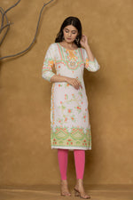 Model in a different pose wearing the white and lime pannel kurta, highlighting the full length and the cheerful floral patterns at the bottom.