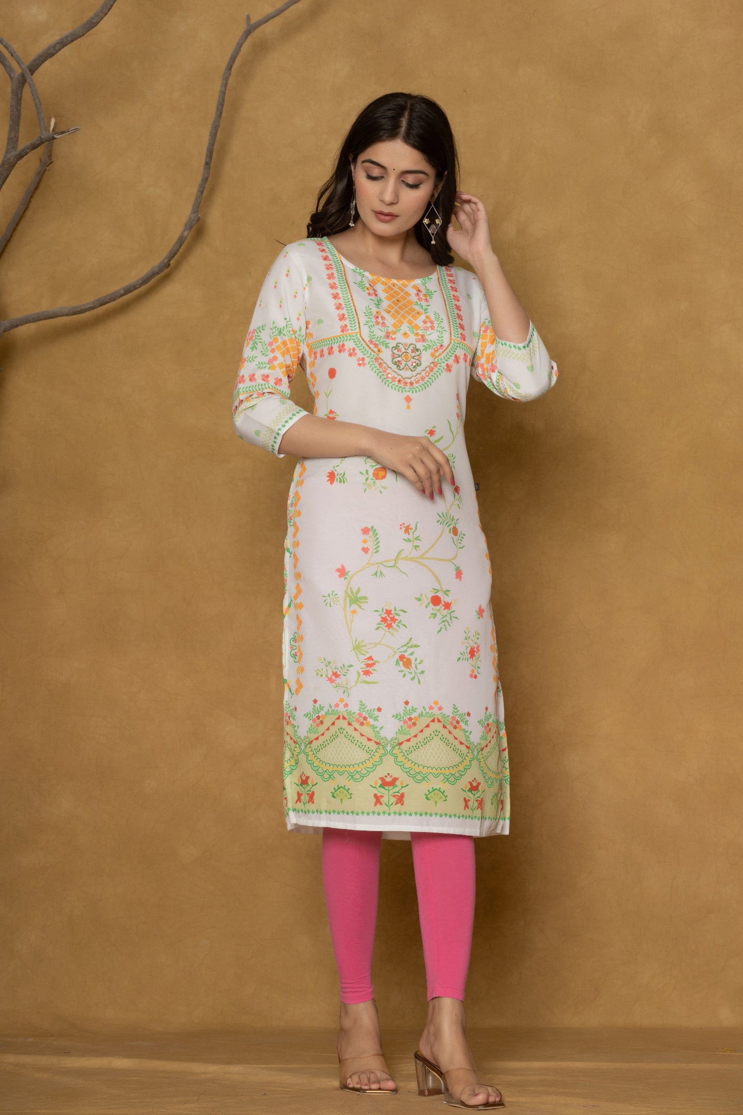 Model in a different pose wearing the white and lime pannel kurta, highlighting the full length and the cheerful floral patterns at the bottom.