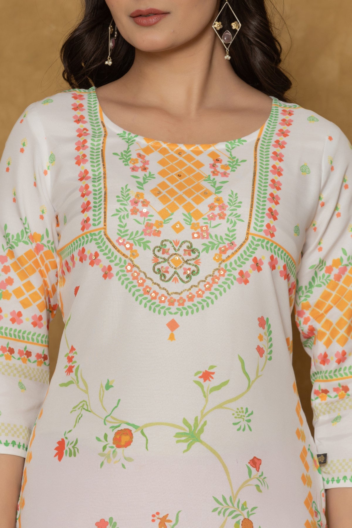 Close-up of the beautiful handwork embroidery and detailing on the round neckline of the white and lime pannel kurta, highlighting craftsmanship.