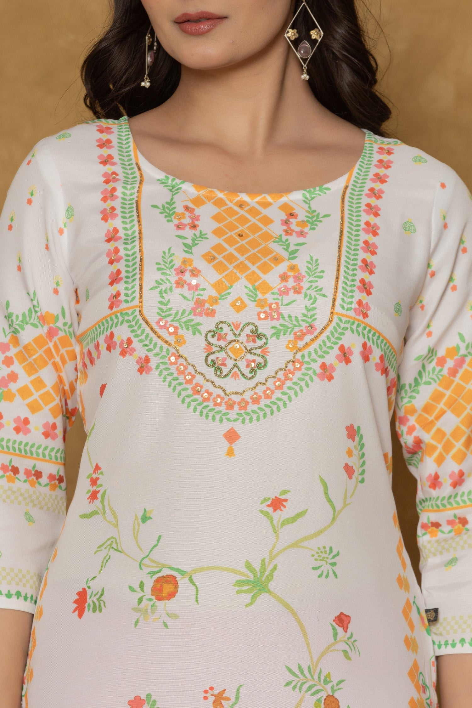Close-up of the beautiful handwork embroidery and detailing on the round neckline of the white and lime pannel kurta, highlighting craftsmanship.