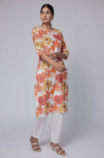 Model in a confident stance, highlighting the full length and overall vibrant floral print design of the white multicolor cotton dobby kurti.