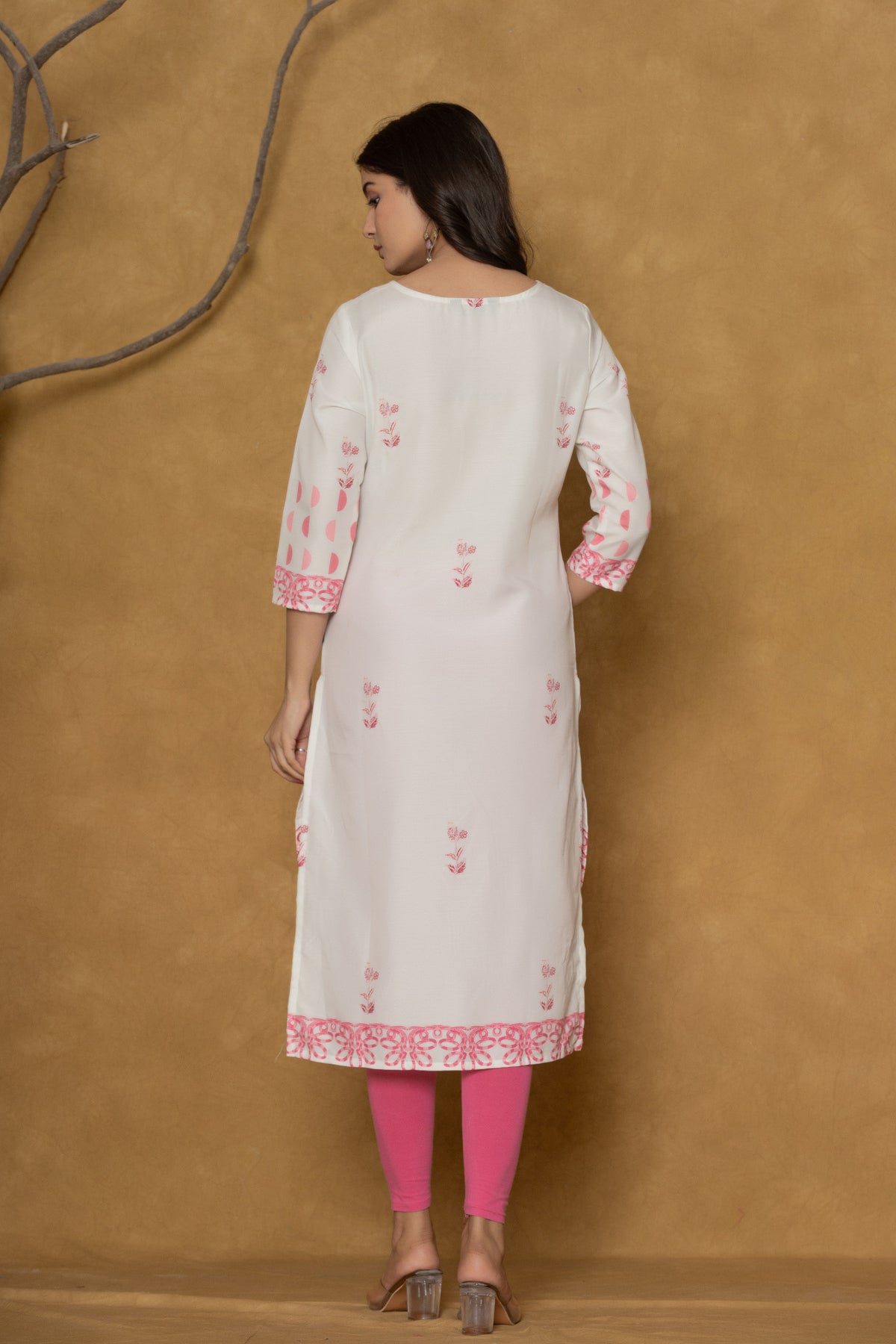 Back view of the white pannel kurta, showing the clean design and the continuation of the hemline pattern.