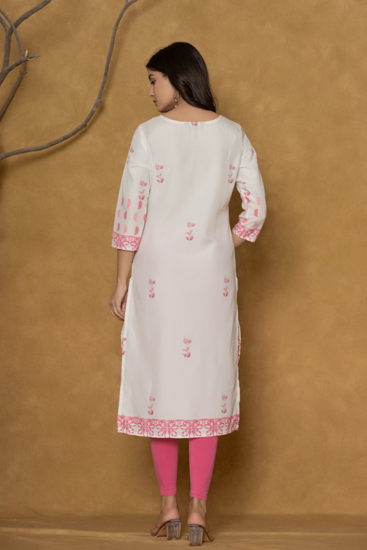 Back view of the white pannel kurta, showing the clean design and the continuation of the hemline pattern.
