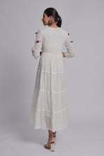 Back view of the white tiered Anarkali dress, showing the consistent fabric pattern and comfortable silhouette.