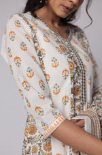 Model in a confident stance, highlighting the full length and vibrant Jaipuri print design of the white and yellow cotton Anarkali set.