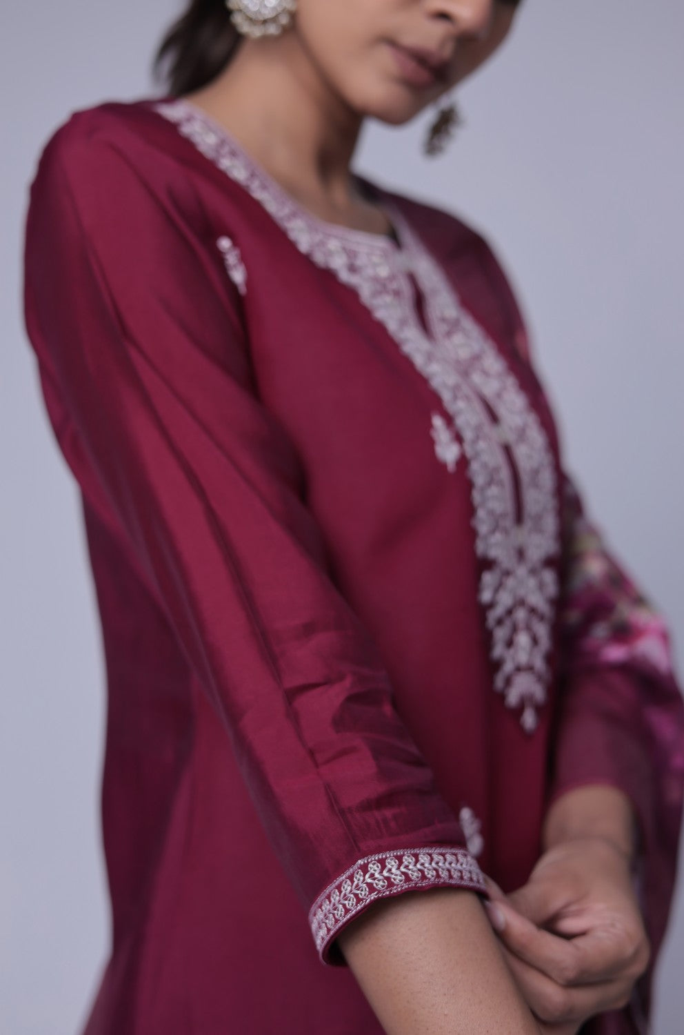 Close-up of the delicate white thread embroidery on the sleeves and cuffs of the wine soft silk kurta.