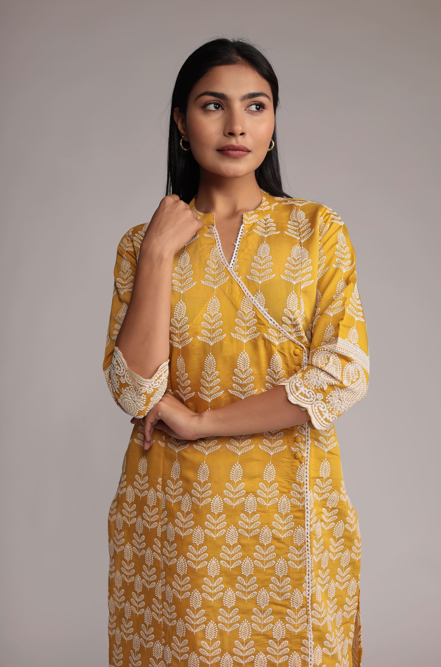 Model gracefully posing in the yellow kurta pant set, showcasing the comfortable movement and elegance of the allover embroidered kurta.